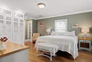 a bedroom with a large white bed and a chair at Majestic Family Home in Saratoga New York in Saratoga Springs
