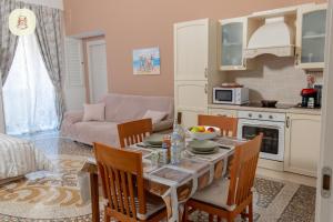 a kitchen and living room with a table and chairs at Le Camelie in Genoa