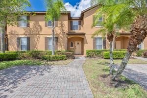 a house with palm trees in front of it at Cozy Stylish Townhome in Davenport