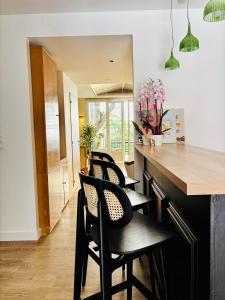 a kitchen with black chairs and a counter with flowers at Hotel Bonaparte in Bastia