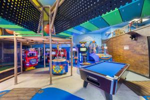 a room with several arcade games and a pool table at Cozy Stylish Townhome in Davenport