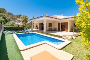 a villa with a swimming pool in front of a house at Villa Gotmar by Sealand Villas in El Port