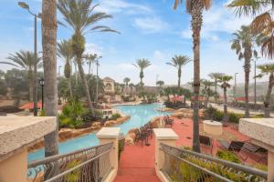a view of the pool at a resort with palm trees at Cozy Stylish Townhome in Davenport