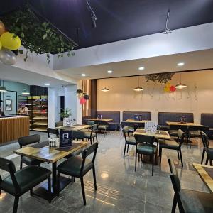 a dining room with wooden tables and chairs at Fluted Nest 16th Floor Wood Avenue- Yaya centre Kilimani in Nairobi