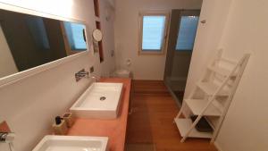 a bathroom with a sink and a mirror at La Pecora Nera B&B in Budoni +24 photos