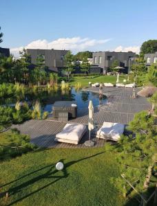 a backyard with a swimming pool and a lawn at Mano Jūra - apartamentų nuoma Mano Jūra 3 kvartale in Palanga