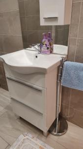 a bathroom with a white sink and a mirror at Apartman Kastel in Kaštela +23 photos