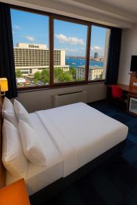 A bed or beds in a room at Taxim Express Bosphorus Hotel
