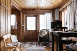 a living room with a desk and a window at Lapland Arctic Cabins in Kemijärvi