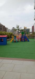 a playground in a park with green grass at Apartamento confortavel a cinco minutos da praia de icarai in Niterói