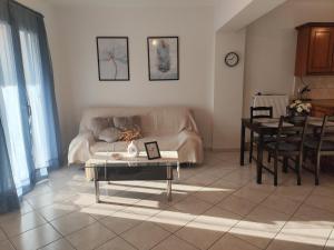 ein Wohnzimmer mit Sofa und Tisch in der Unterkunft Perdika Sunset in Pérdika + 12 Fotos