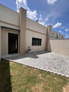 a house with a driveway in front of it at Casa aconchegante 2min do centro in Primavera do Leste