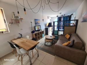 a living room with a couch and a table at Sunset studio Bečići in Bečići