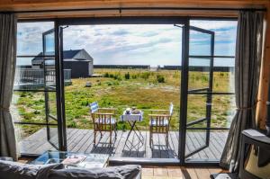 a screened in porch with a table and chairs at Cabu by the sea in Dymchurch