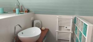 a bathroom with a sink and a toilet in it at Charmante Bergerie restaurée in Cazaux-Debat