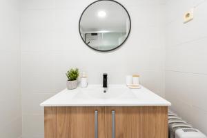 ein Badezimmer mit einem weißen Waschbecken und einem Spiegel in der Unterkunft Apartamento de 1 dormitorio cerca de Plaza España-Madrid Temporal PEZ14 in Madrid + 44 Fotos