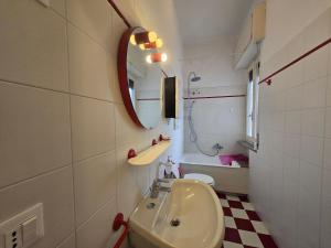 a bathroom with a sink and a mirror at Eden - By Ligooria in Pietra Ligure +13 photos