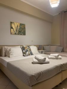 a bedroom with a large bed with towels on it at Niko's art Villa in Chania in Perivólia +22 photos