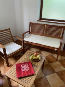 a room with two chairs and a table with a bowl of fruit at Villa am Schwarzen Meer in Eforie Nord +34 photos