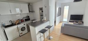 a kitchen and living room with a washing machine at T2 cœur de ville avec terrasse in Agen
