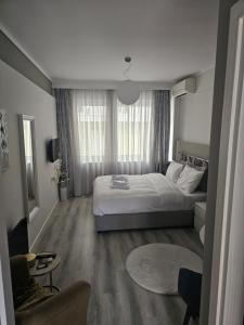 a bedroom with a bed and a large window at TRISAP Luxury Suites T Suite in Thessaloniki