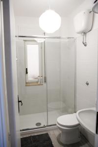 a bathroom with a shower and a toilet and a sink at Appartamento Centrale Scalea in Scalea +10 photos