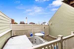 a hot tub on the balcony of a house at North OC Condo 2BR w pool, private hot tub & views of Fenwick Lighthouse in Ocean City