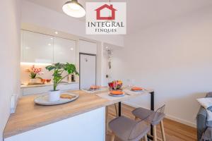 a kitchen with a table and chairs in a room at El Refugi de Mar in Palamós