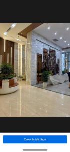 a lobby with potted plants in a building at Green Diamon Luxury Apartment in Ha Long +13 photos