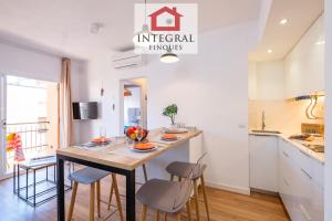 a kitchen with a table and chairs in a room at El Refugi de Mar in Palamós +8 photos