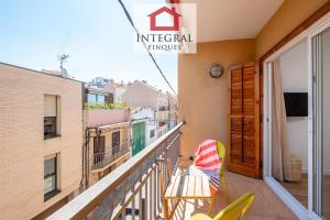 a balcony with a table and a chair on it at El Refugi de Mar in Palamós