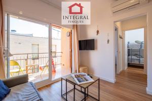 a living room with a couch and a balcony at El Refugi de Mar in Palamós