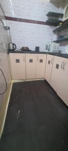 a room with a kitchen with a counter top at Mandira's Home in Kolkata