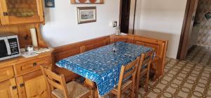 a kitchen with a table and some chairs and a counter at Attico Alvorada in Porto Santa Margherita di Caorle