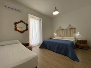 Postel nebo postele na pokoji v ubytování Isid'Oro Rooms