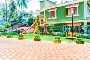 a playground in front of a building with a slide at Luxury 1BHK Premium Furnished Flat,WiFi, Near BAGA in Arpora