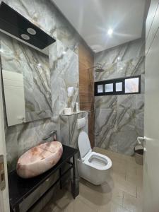 a bathroom with a toilet and a sink at Sueño Luxury Villa in Durrës