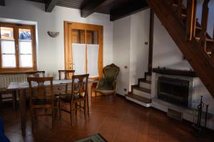 a dining room with a table and chairs and a fireplace at Casa Orfea in Stresa