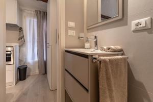 a bathroom with a sink and a towel at La Mansardina Padovana - Historic Center in Padova +25 photos
