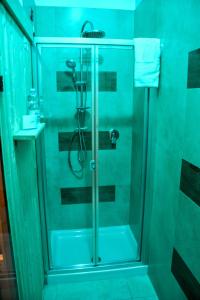 a shower with a glass door in a bathroom at Brain Rooms & Suite in Pagani