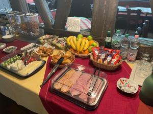 a table with a buffet of food and fruits and vegetables at Hotel Alt Nürnberg in MHG +17 photos