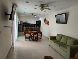a living room with a couch and a table and chairs at Dalia in Cedro