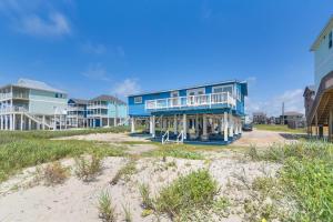 a blue house with a balcony on a beach at Oceanfront Galveston Home on Terramar Beach in Galveston