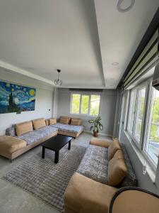a living room with couches and a table at Panorama house in Denizli