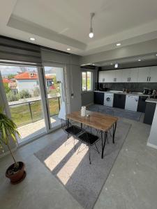 a large kitchen with a wooden table and chairs at Panorama house in Denizli