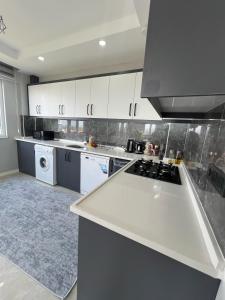 a kitchen with white cabinets and a white counter top at Panorama house in Denizli +24 photos