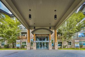 an entrance to a building with a large roof at Silver Rock by StayIn in Fernie