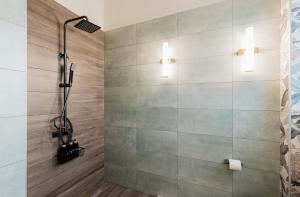 a shower with a glass door in a bathroom at Alkyoni luxury apartments Katakolo in Katakolon +66 photos