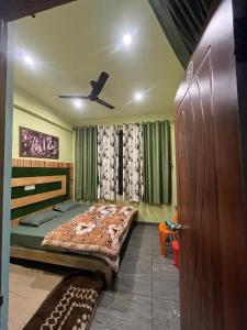 a bedroom with a bed and a ceiling fan at Mayank Palace in Almora +34 photos