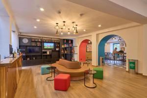 a living room with a couch and a table at Centro by Casa Andina Cusco Saphi in Cusco